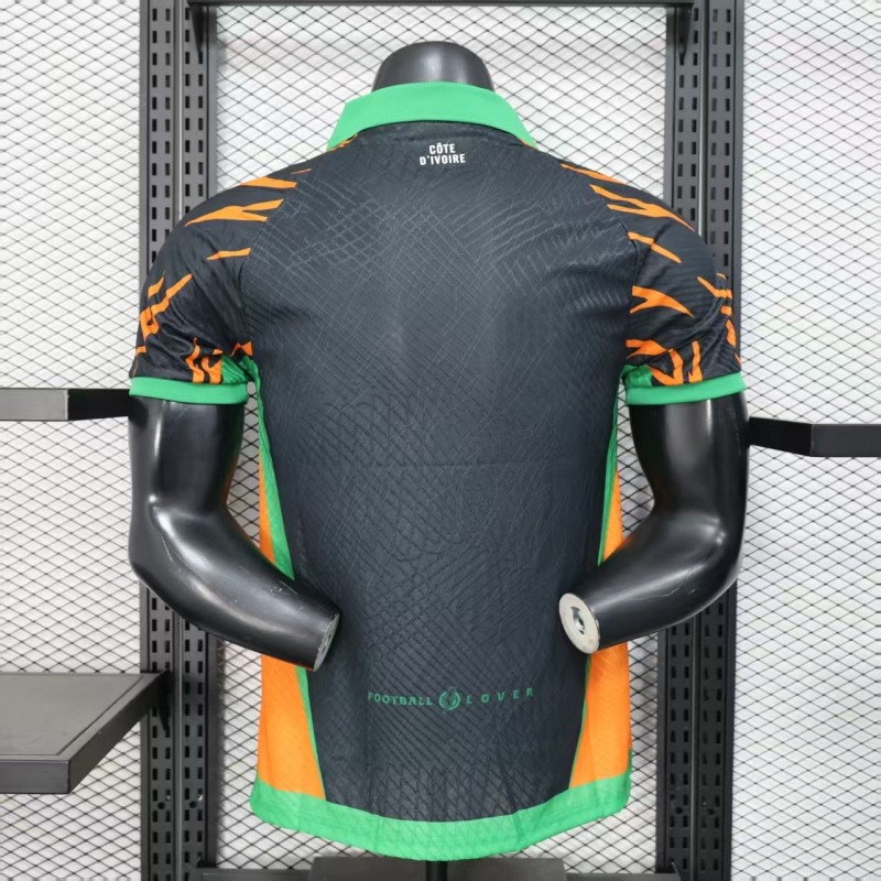 Player Version 2025 Ivory Coast Black with Elephant Graphic and Orange Stripes Jersey